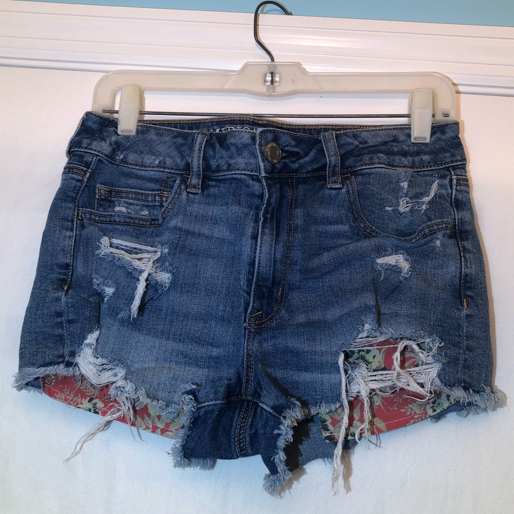 Girls Jean shorts with floral pattern pockets.
